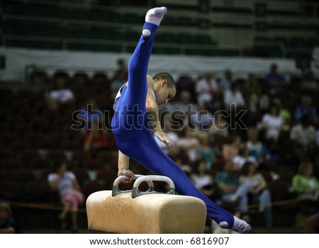 Young man competing on the pommel