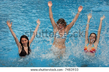 Three young girl jumps in the pool