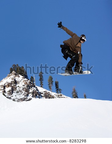 Snowboarder jumping high at Lake Tahoe resort
