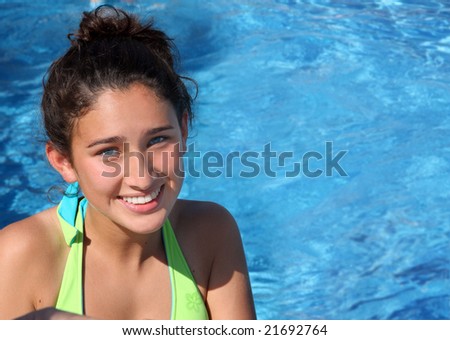 stock photo Pretty smiling teen girl in a pool