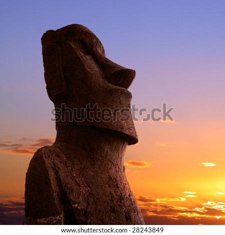 A stone statue on Easter island at sunset
