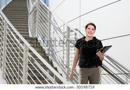 A young business woman standing on the stairs