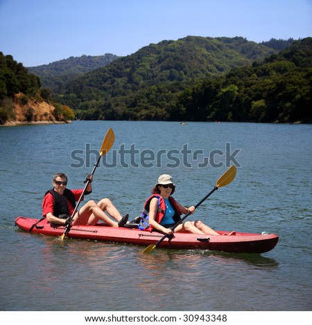 A middle age couple kayaking on the lake