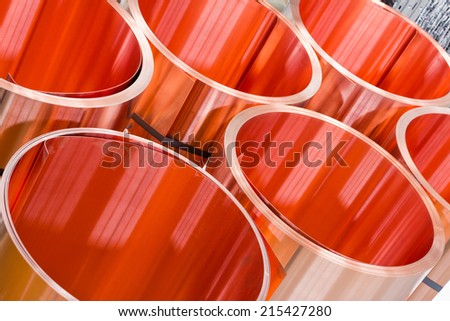 closeup of red copper sheet in rolls