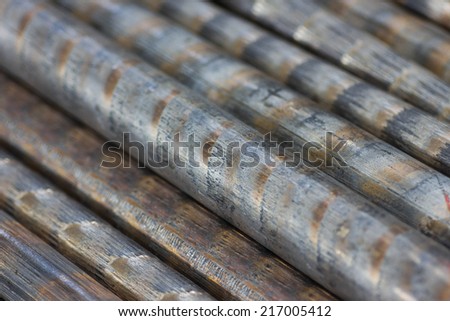 background of a pile of bronze rods closeup