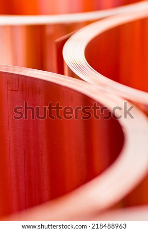 closeup of red copper sheet in rolls from the selected focus