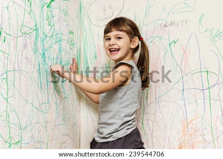 girl drawing with crayons on the wallpaper girl drawing with crayons on the wallpaper
