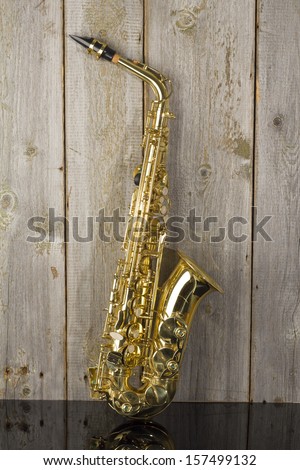 golden shiny saxophone on wood background