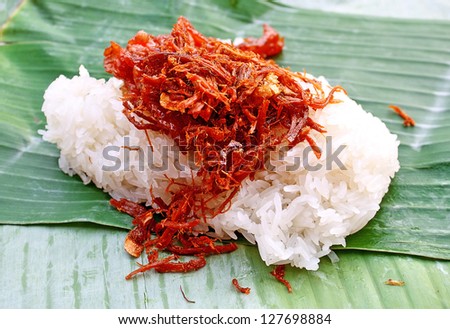 Sticky rice with sweet pork chop on banana leaf plate. Thai local food.Northern thai food