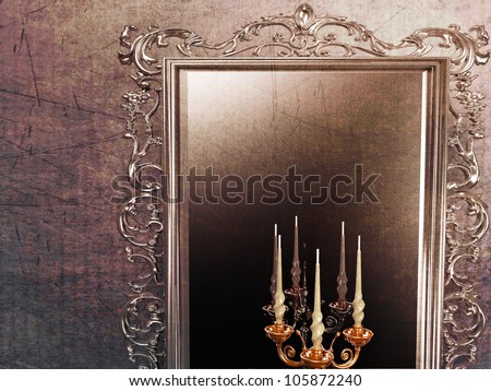a large antique mirror and candle holder