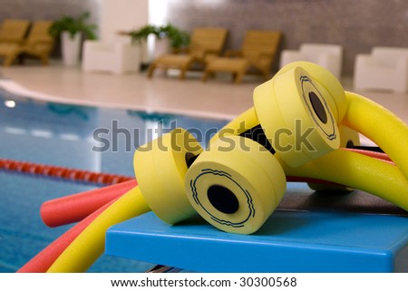 aqua noodles dumbbells for aqua aerobics on the coast in pool
