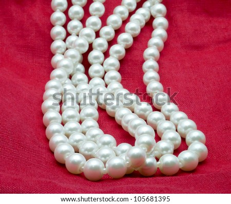 nice Pearl necklace on red background