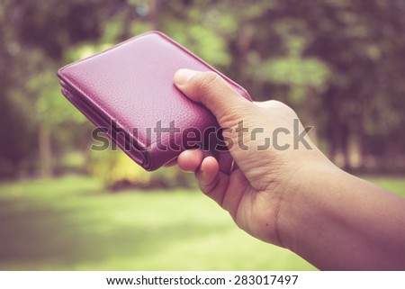 Hand and wallet with filter effect retro vintage style