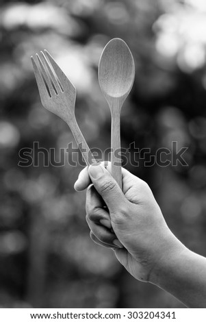 Woman hand and wooden spoon with filter effect retro vintage style