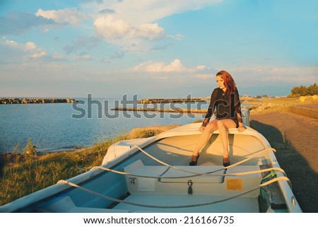 Beautiful woman sitting on a boat