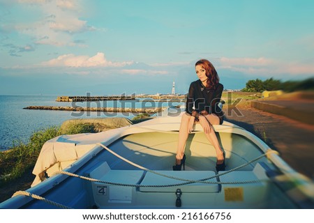 Beautiful woman sitting on a boat