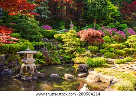 Japanese garden with pond behind house