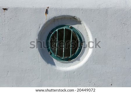 Round window in the wall of ship