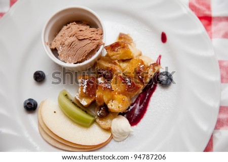 Fruit dessert with chocolate ice cream and baked apple bread