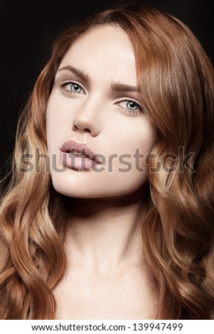 Beautiful young model with natural makeup clean skin, long curly hair
