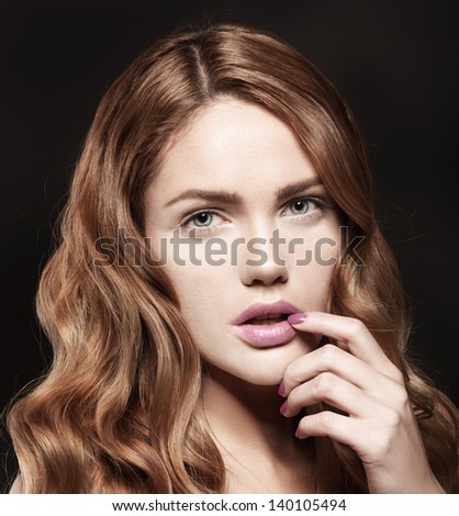 Beautiful young woman with magenta lips and colorful manicure on black background, natural summer makeup