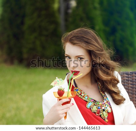 Fashion young model woman drink cocktail outdoors, sunny weather