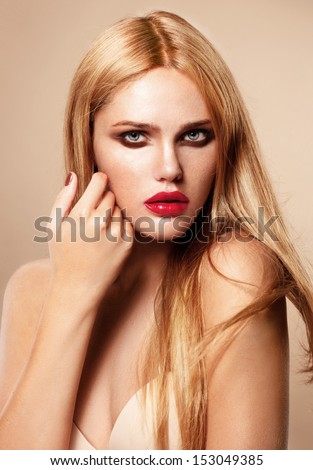 Beautiful young model with red lips and manicure fashion, perfect light skin, sunburn