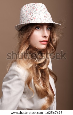 Portrait of beautiful fashion blonde woman with a hat and shine blonde hair