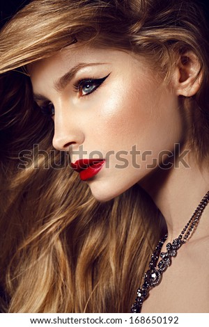 Fashion young model with red lips and shine long blonde hair studio shot and shine hair