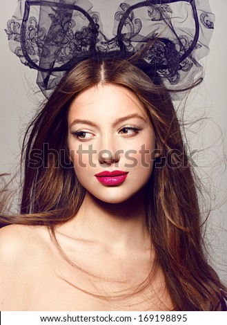 Close-up portrait of beautiful model with bright lips. on grey background fashion party style