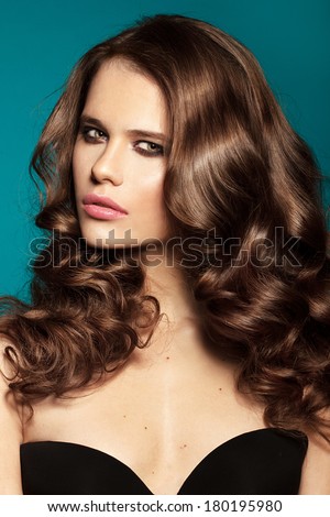 Beautiful face of a glamour woman with smoky eyes make up.  studio shot and shine hair