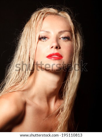 attractive young model with red lips and bright make-up black background, wet hair