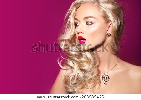 Photo of beautiful woman with magnificent blonde hair. pink background. Fashion photo salon