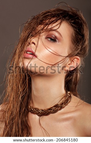 Beautiful young model with long wet hair, light makeup, fresh summer look with damp beach hairstyle