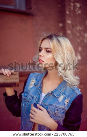 Fashion model with blonde hair, outdoors, big lips