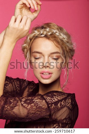 Young fashion model with big lips. Studio shot. Pink color. Blonde.
