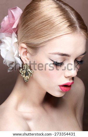 Fashion model with classic make up. Flowers. Spring look. Dolce style. Perfect skin, blonde hair. Big pink lips. Art background.