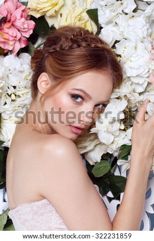 Portrait of a beautiful fashion bride, sweet and sensual. Wedding make up and hair. Flowers background. Art modern style. Blue eyes