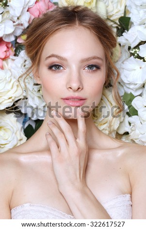 Portrait of a beautiful fashion bride, sweet and sensual. Wedding make up and hair. Flowers background. Art modern style. Bl