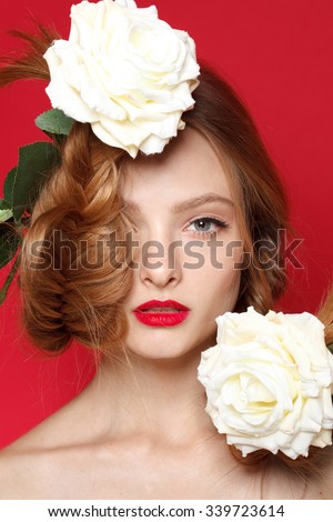 Fresh young fashion model with red lips. Wedding make up. White roses. Spring style.\
Blue eyes. Blonde hair.