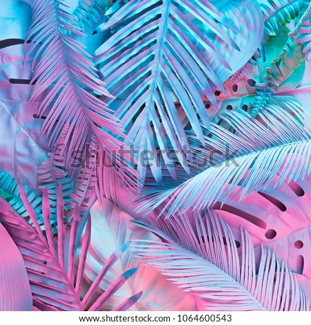 Tropical and palm leaves in vibrant bold gradient holographic neon  colors. Concept art. Minimal surrealism background.