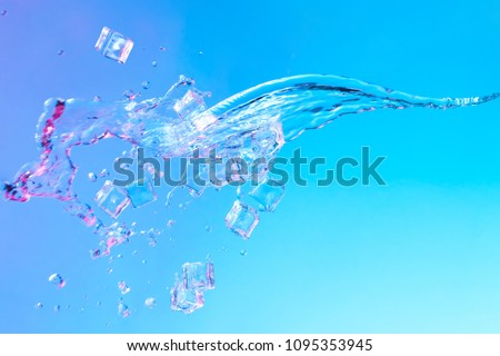 Water with ice cubes in vibrant bold gradient purple and blue holographic color lights. Concept art. Minimal summer surrealism.