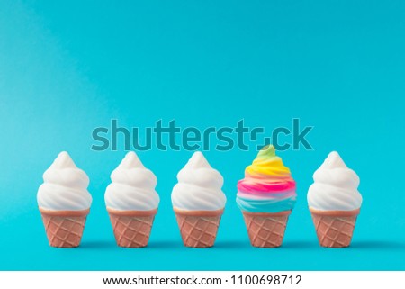 Colorful and white ice cream on pastel blue background. Creative minimal summer concept.
