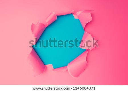 Vivid pink torn paper. Burst hole background. Minimal abstract colorful wallpaper concept.