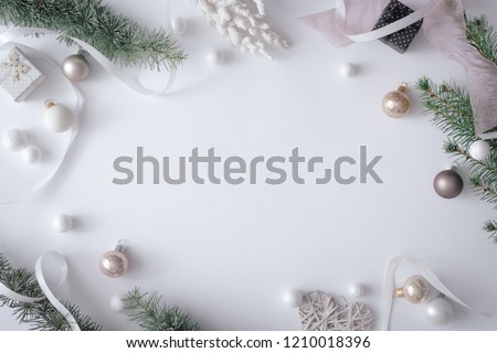 Winter Christmas table layout with New Year decoration on pastel grey background. Minimal nature concept. Flat lay top view composition.