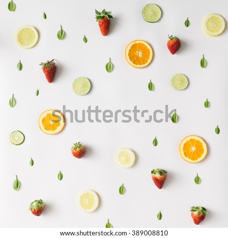 Colorful pattern made of citrus fruits, leaves and strawberries