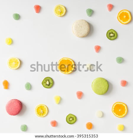 Colorful bright fruit pattern with sweets on white background. Flat lay.