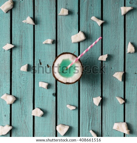 Coconut pattern on blue wooden background. Minimal concept. Flat lay.