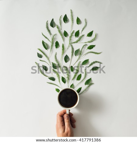 Coffee cup with leaves. Flat lay. Nature concept.