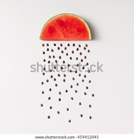 Watermellon slice with seeds raining. Flat lay. Weather concept.